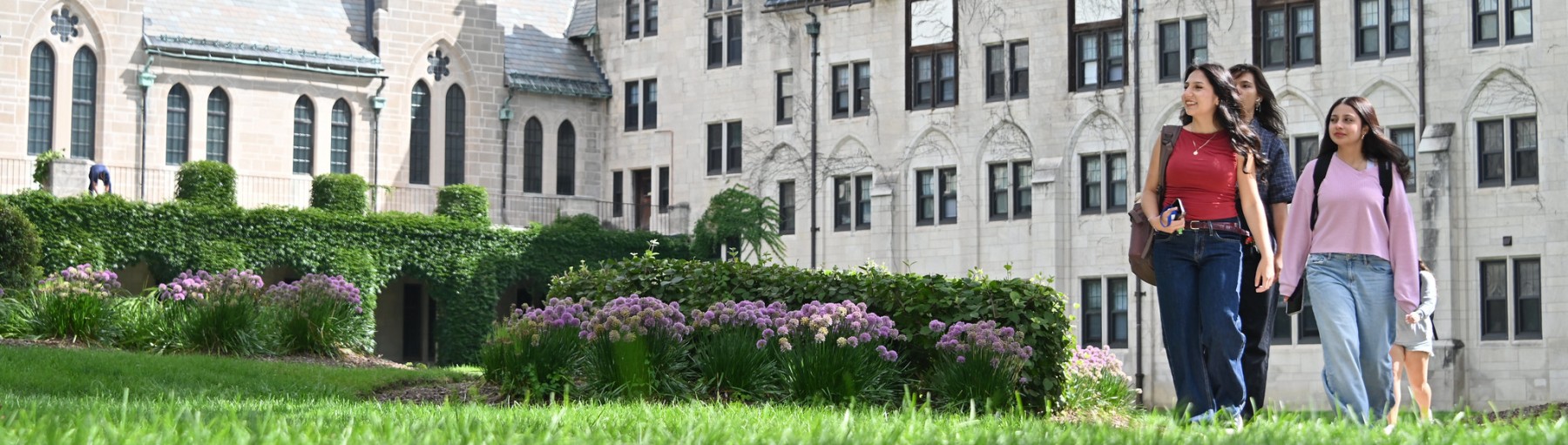 Three students walking on campus