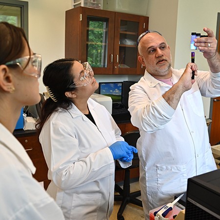 Professor and students in chemistry lab