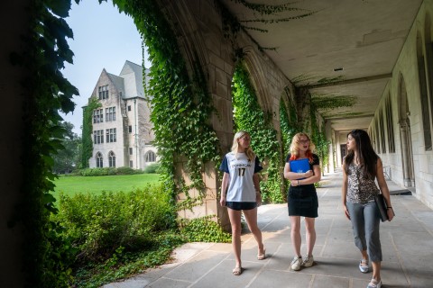 Three female students in the cloister walk
