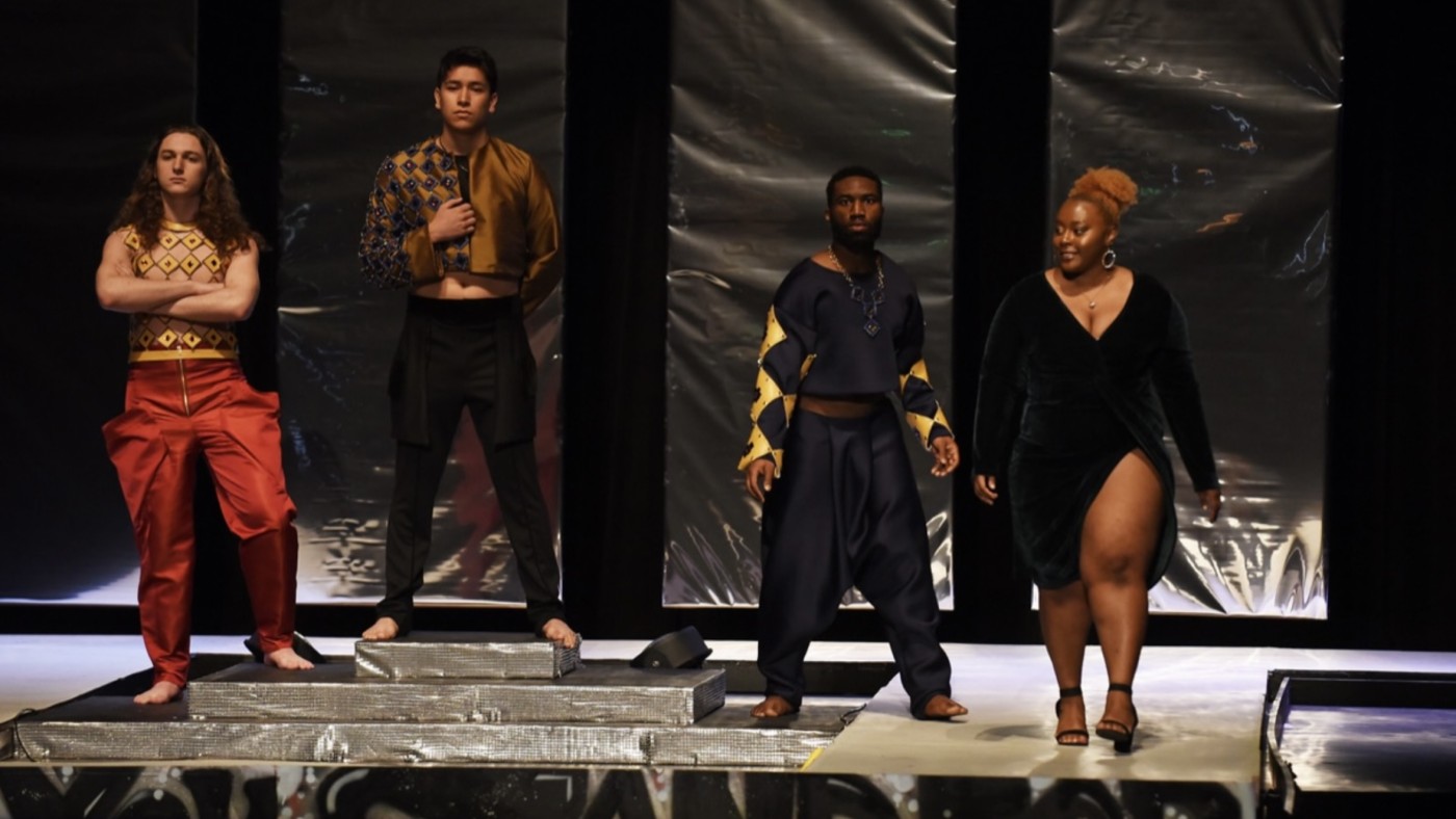 Models on stage wearing outfits designed by students at Dominican University's Annual Fashion Show