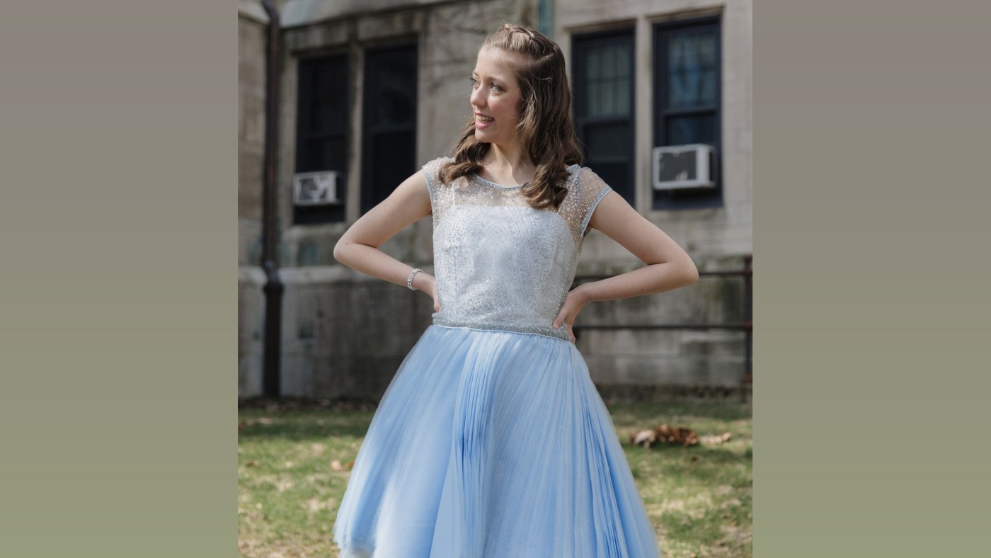 Model wearing outfit designed by student walking on stage at Dominican University's Annual Fashion Show