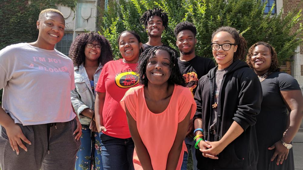 A group of black students outside facing camera