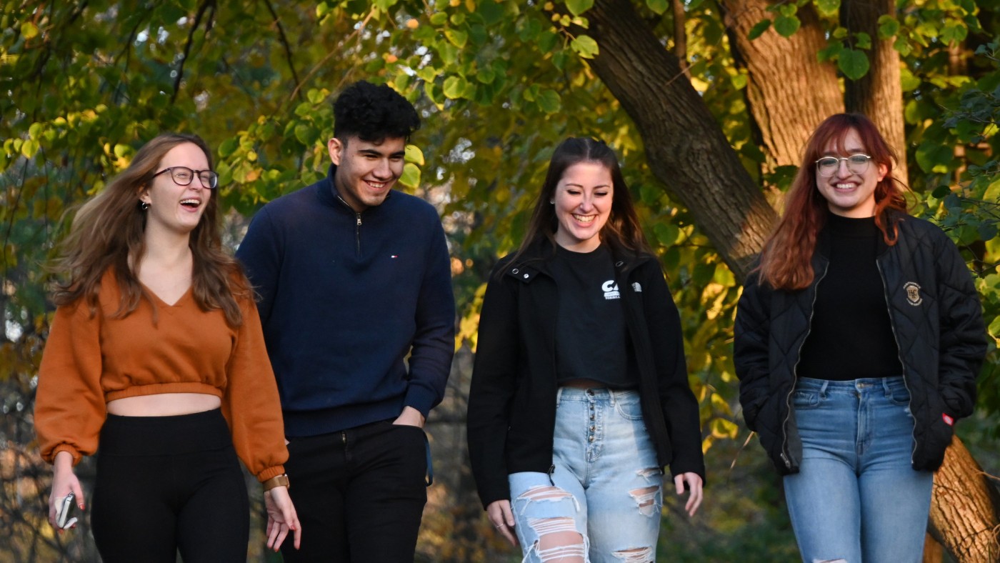 Four students walking on campus