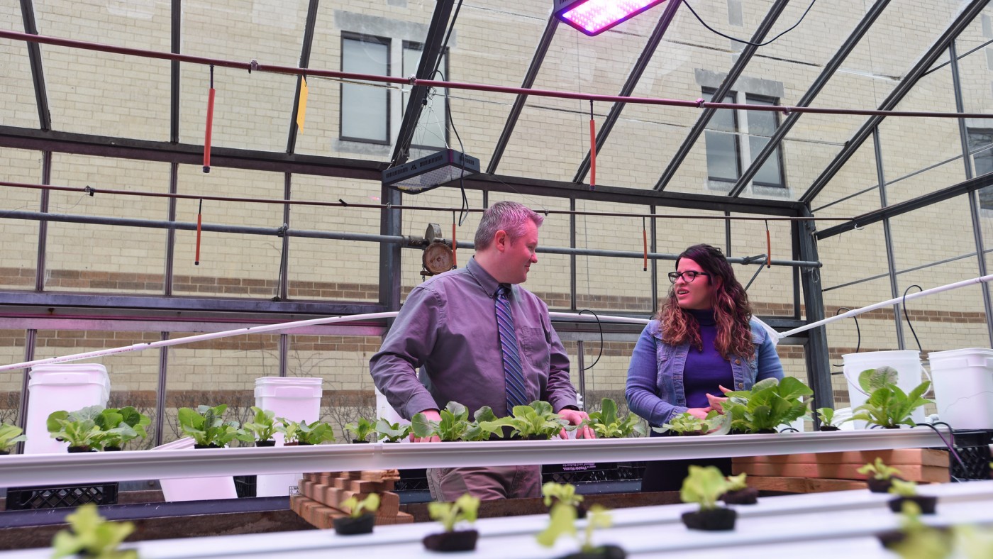 Two people in greenhouse