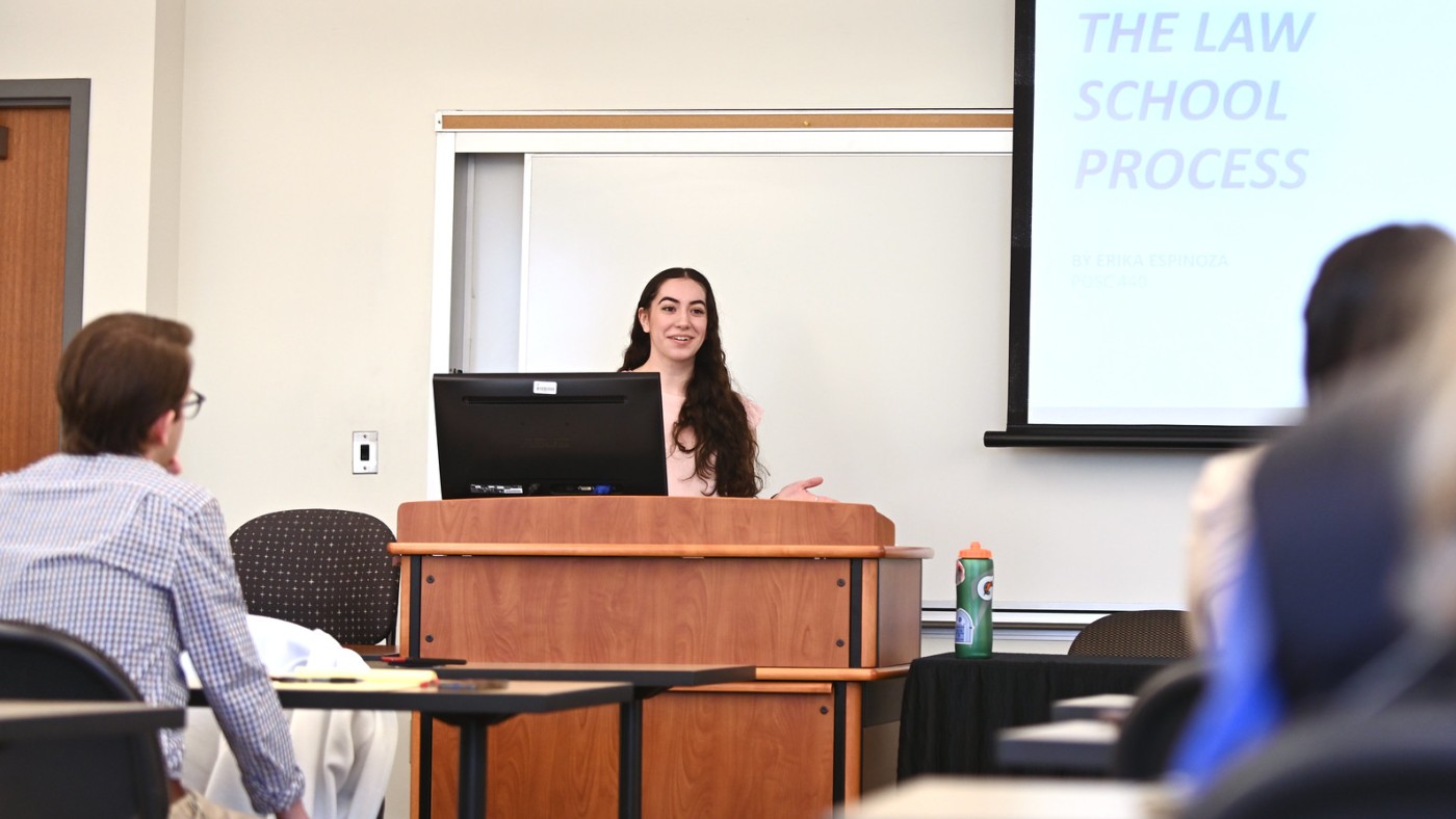 Student presenting at podium