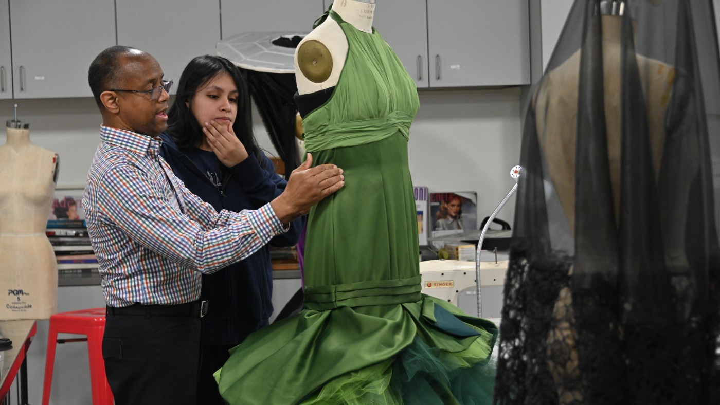 A professor and student work on a garment in Dominican University's Fashion Lab.