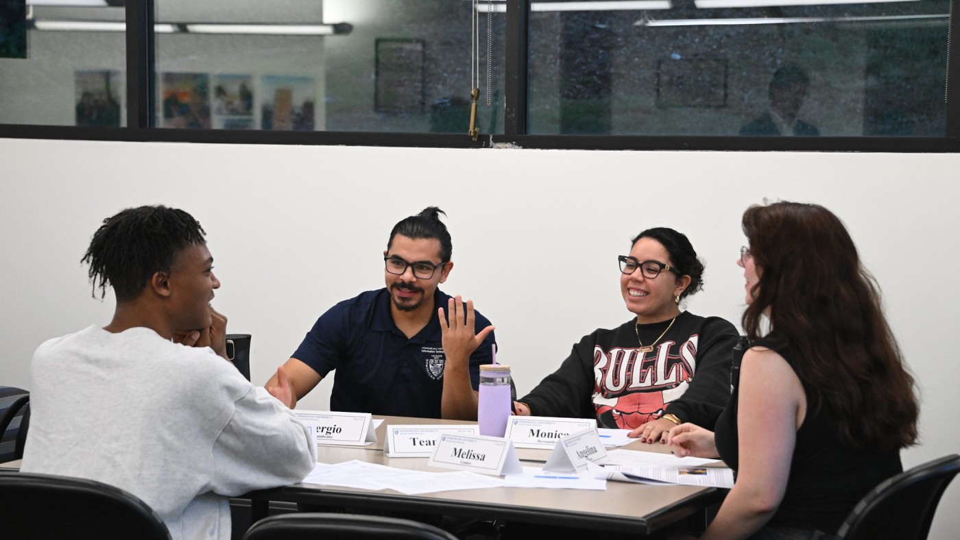 Four students in classroom at a table