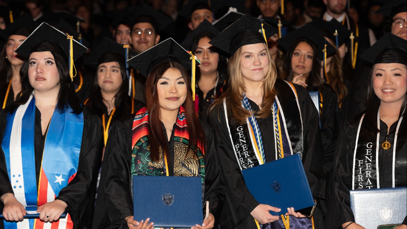 Undergraduate students at Spring Commencement wearing graduation caps and colorful stoles representing heritage