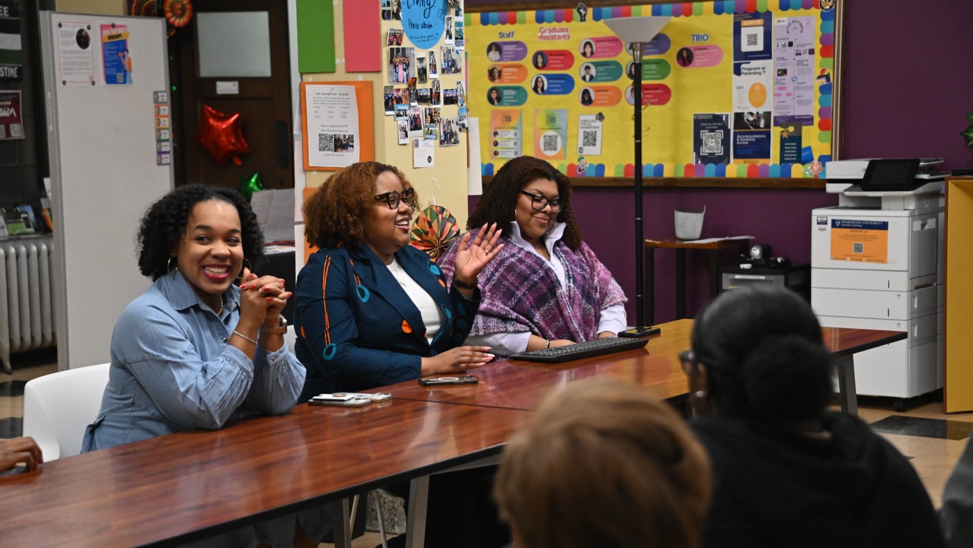 Three females on a panel at a table