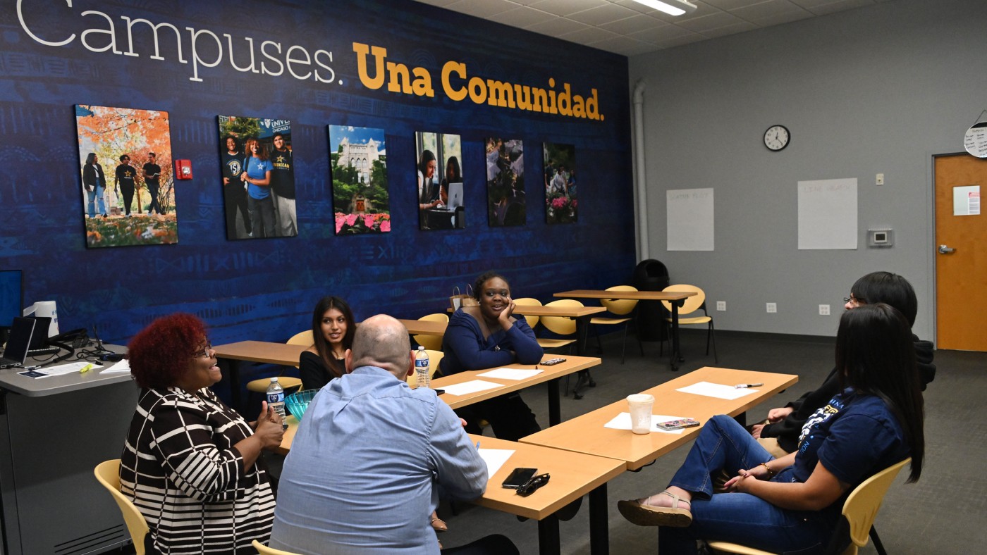 Adults at a conference table at Chicago Campus