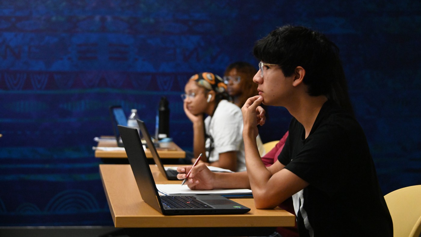 Students with laptops in classroom