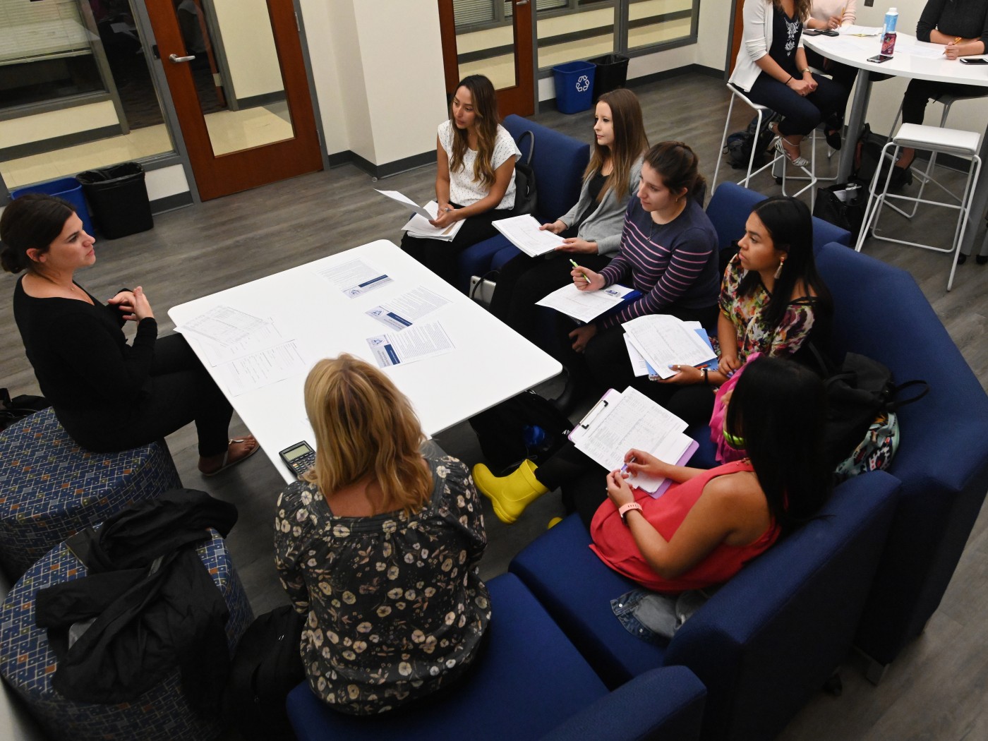 Students sitting around table with faculty member