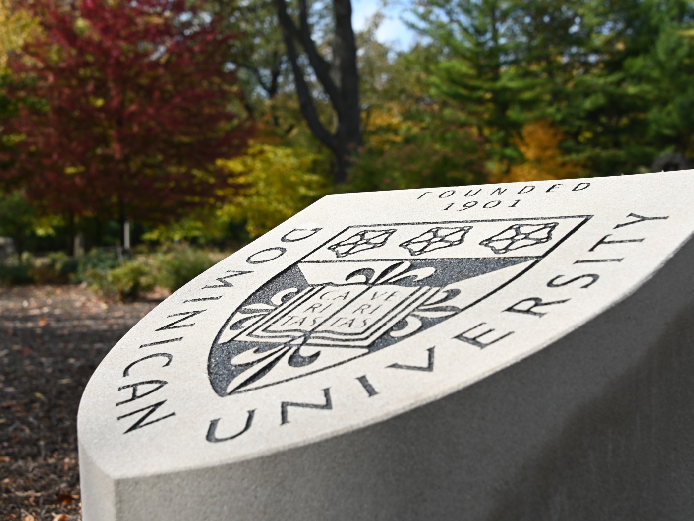 Dominican University's seal shown on a stone on campus
