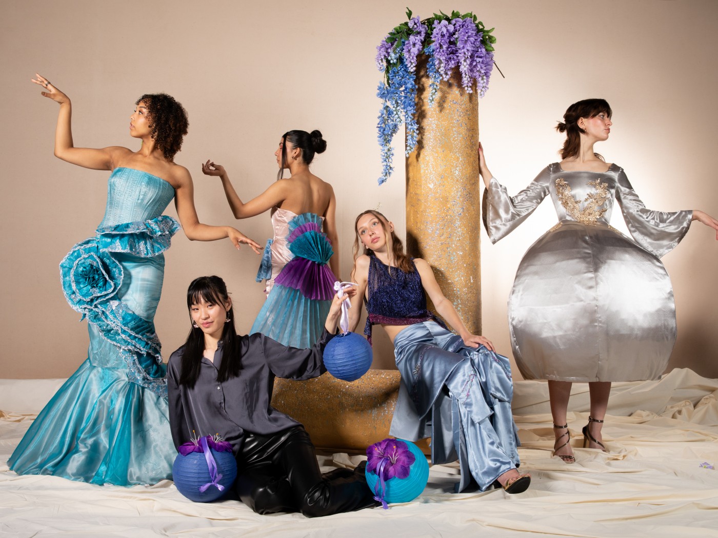 Models pose in garments created by Dominican University's fashion design students.