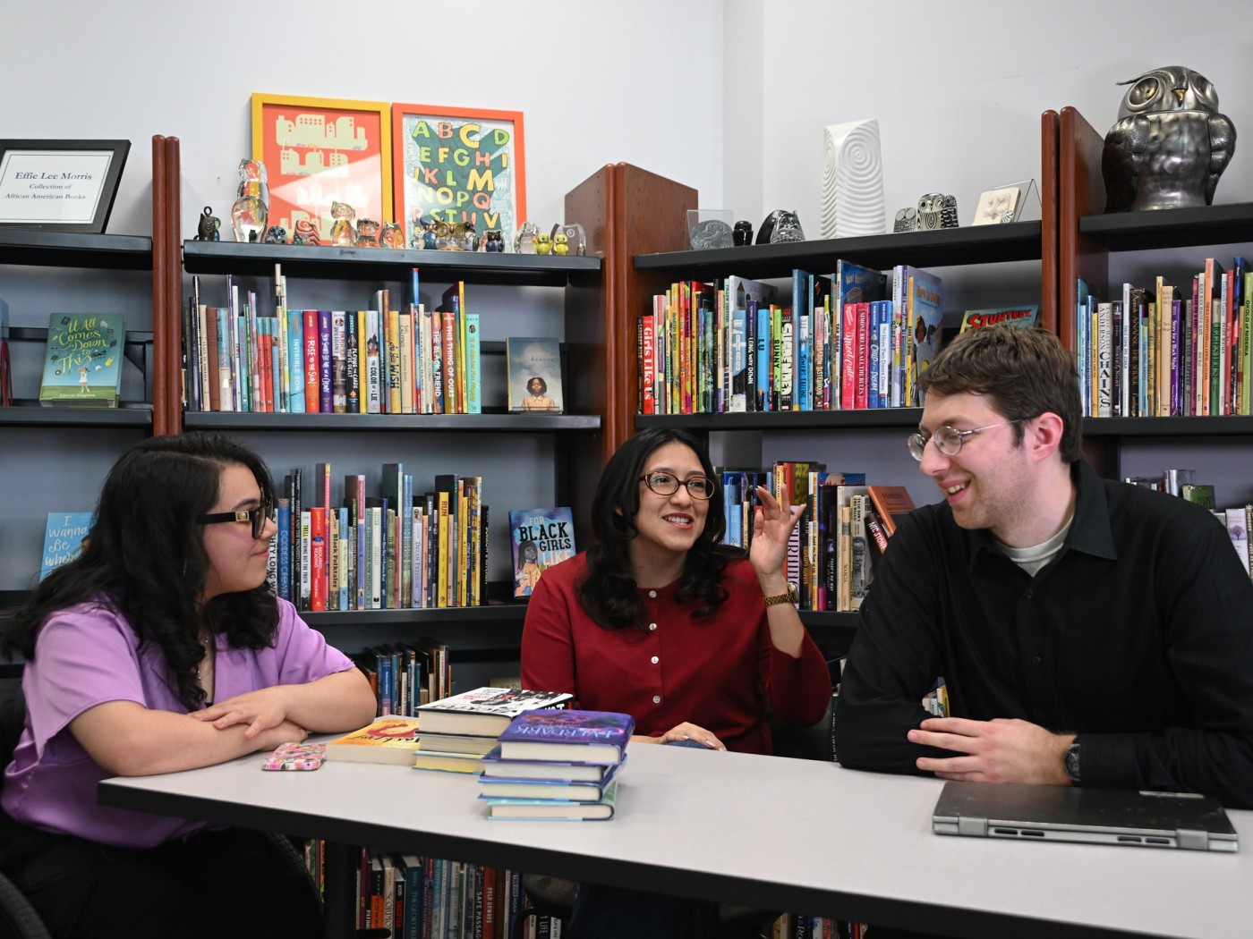 Three students working at a table