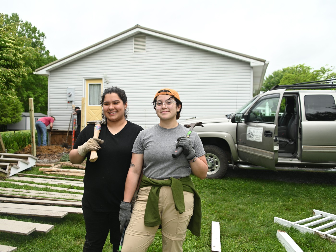 Two students with carpentry tools and supplies