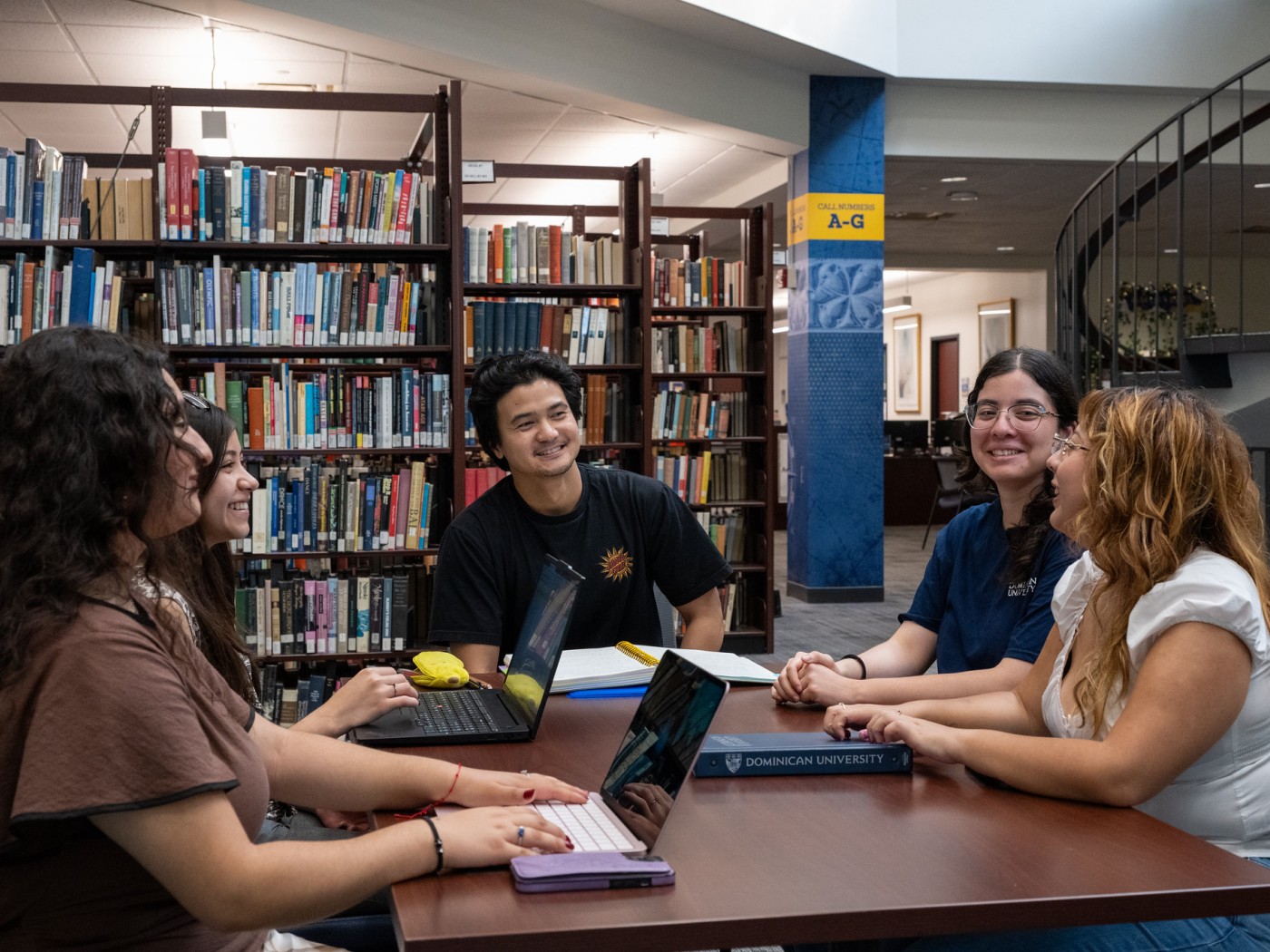 Students seated at a table in the library